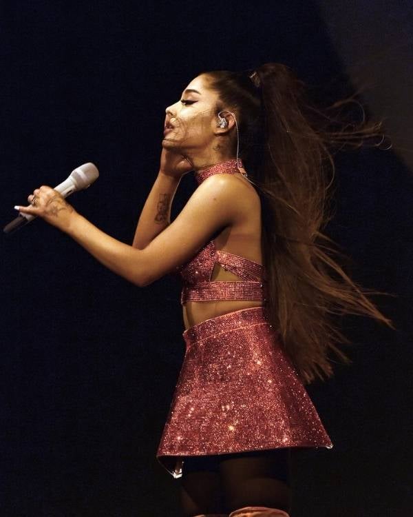 Photo of Ariana Grande singing.