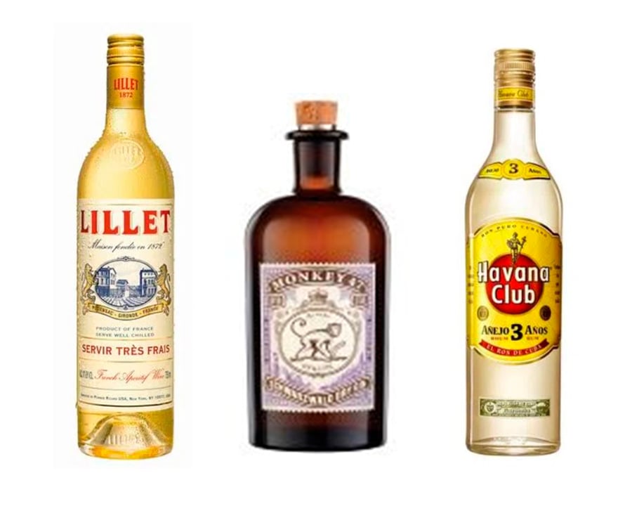 Três garrafas de bebidas, uma o Lillet, uma o gin Monkey 47, a outra o rum Havana Club.