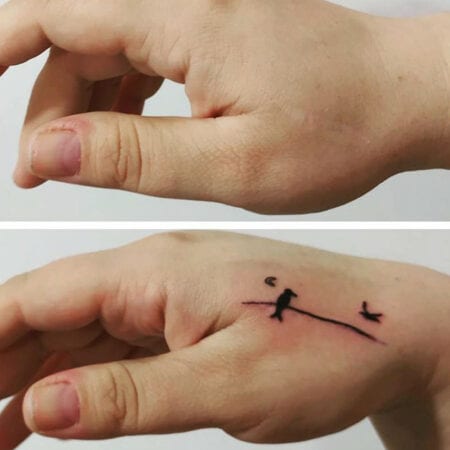 Tatuagem minimalista de pássaro cobrindo cicatriz nas mãos