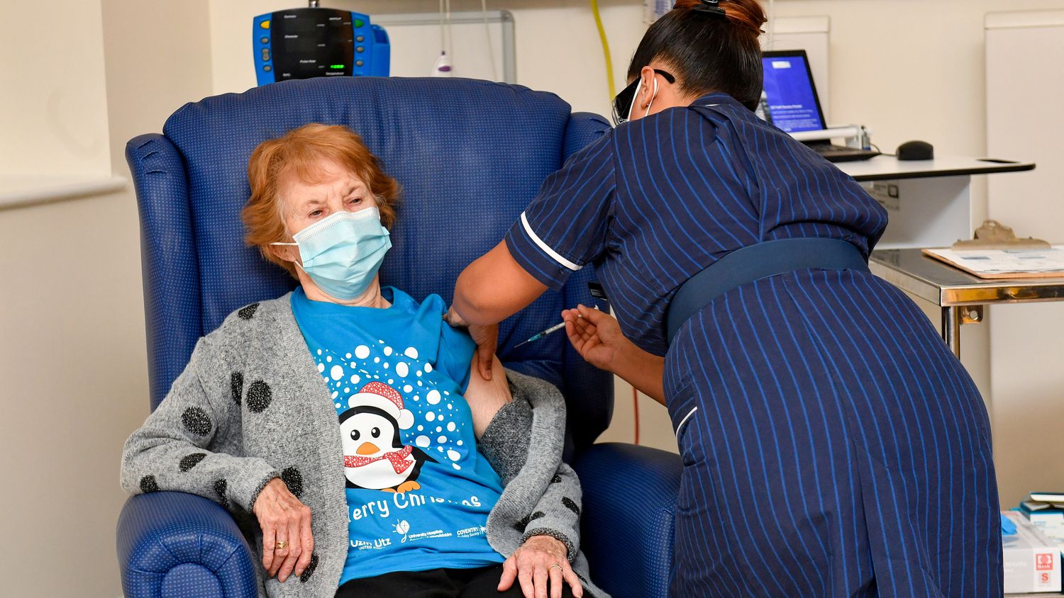 Foto de mulher de 90 anos recebendo primeira dose da vacina contra Covid-19.