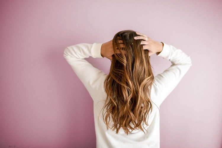 mulher de costas mostrando cabelos longos e saudáveis