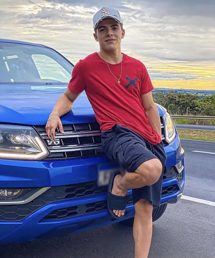 Foto de Thomaz Costa com carro azul Foto de Thomaz Costa com carro