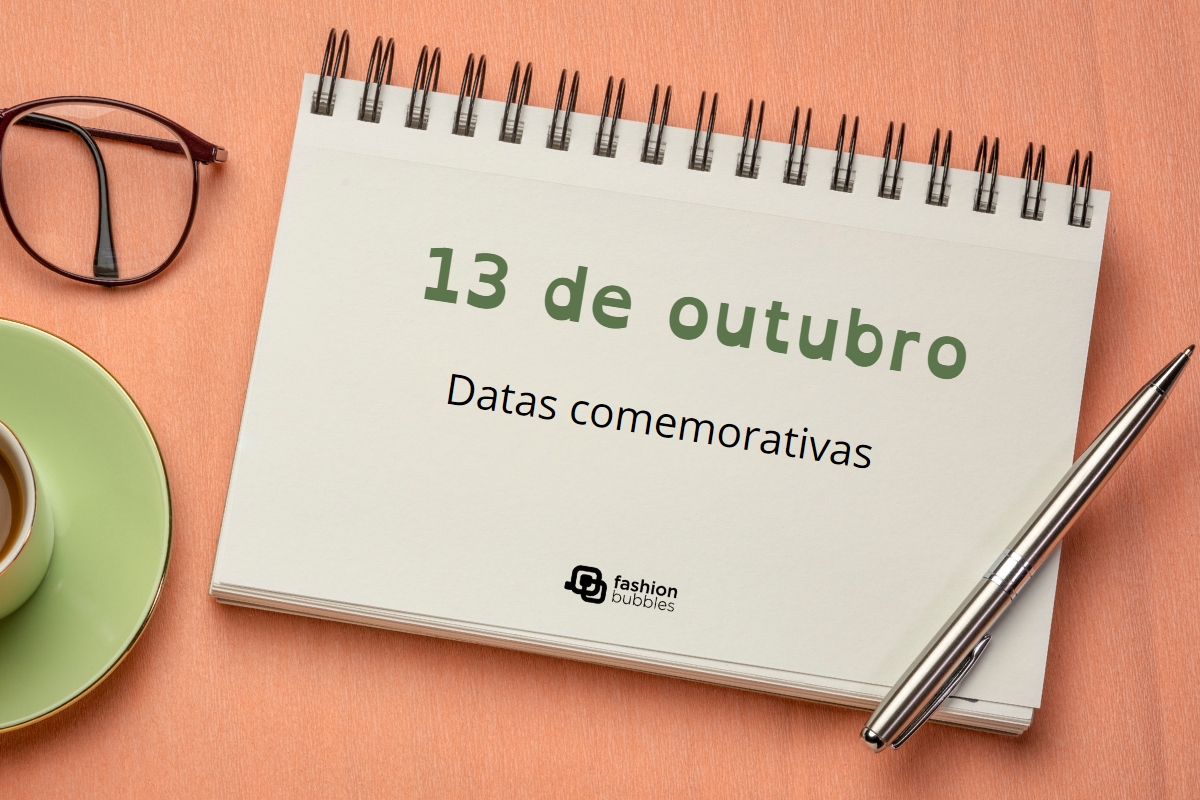 Imagem em fundo laranja comóculos, xícaras e caderno. No caderno lê-se em verde "13 de outubro", e em preto "Datas Comemorativas". Abaixo logotipo do Fashion Bubbles.