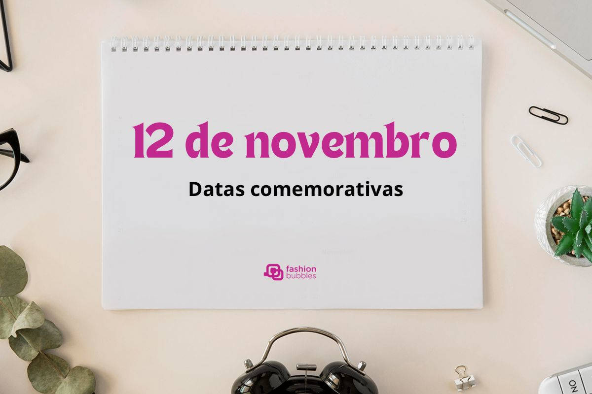 Foto de prancheta em mesa de escirtório com a frase "12 de novembro" escrito em rosa