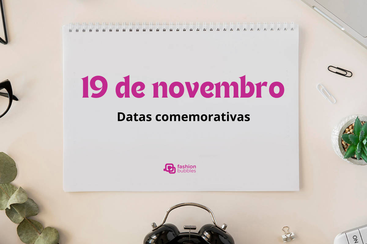 Foto de prancheta em mesa de escirtório com a frase "19 de novembro" escrito em rosa