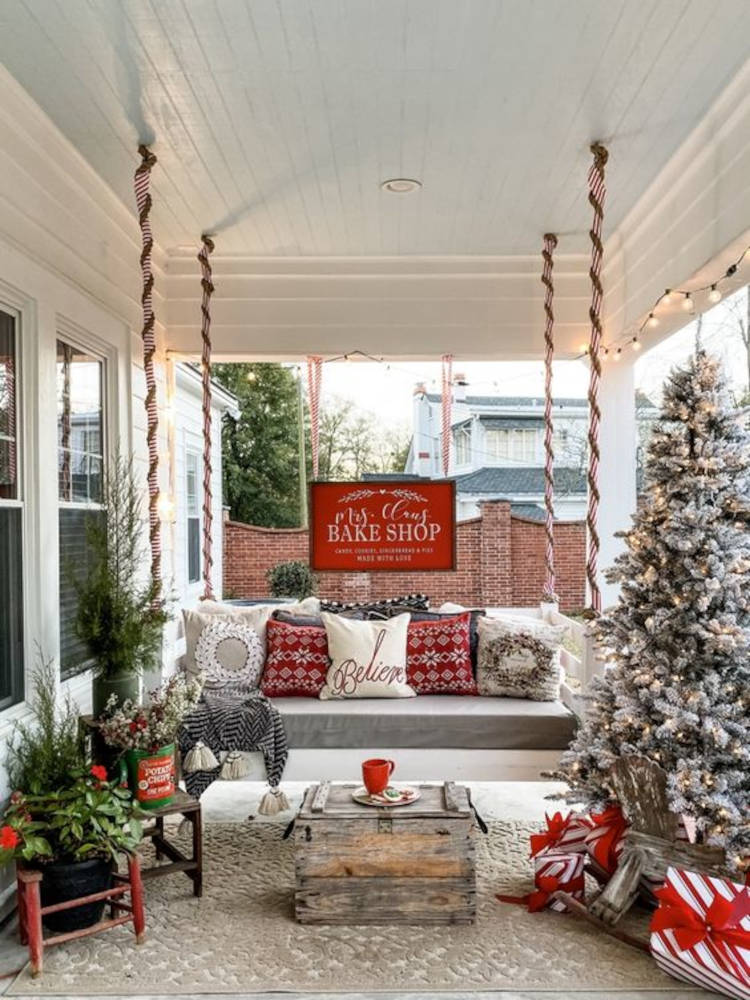 Varanda com balanço e almofadas natalinas. Decoração de natal para jardim em vermelho, branco e verde.