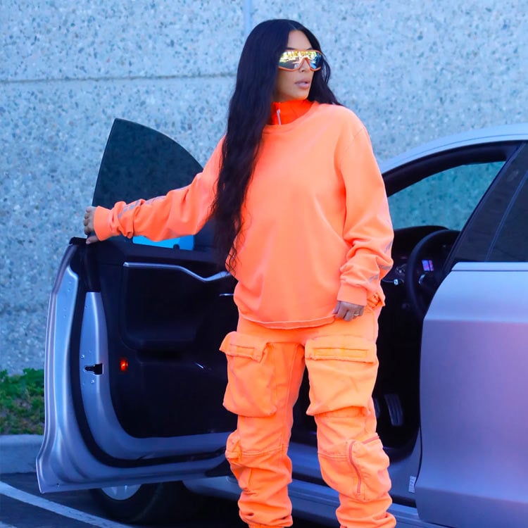 kim kardashian usa moletom oversized e calça cargo, as duas peças laranja neon