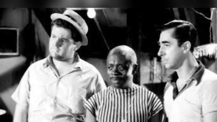 Jô Soares ao lado de Otelo e Akito em uma foto preto e branco, todos os três em cena