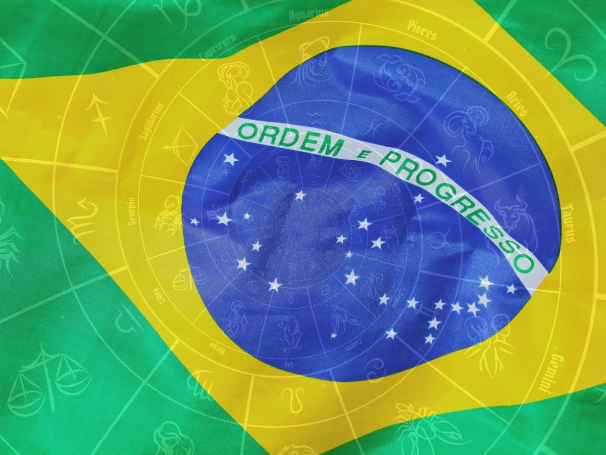 Foto de bandeira do Brasil com símbolos astrológicos.