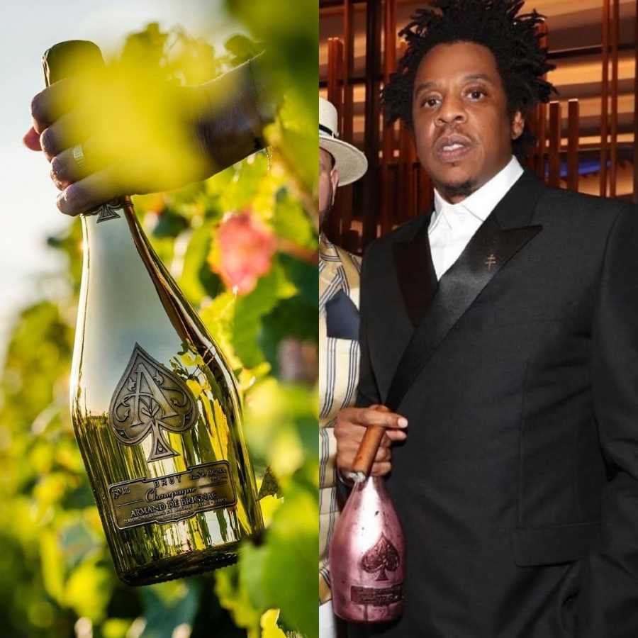 Imagem de mão segurando garrafa do champagne Armand de Brignac. Ao lado, marido de Beyoncé, Jay Z, segurando outra garrafa.