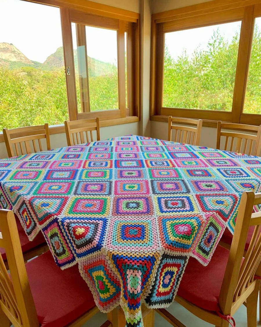 Toalha de mesa de crochê quadrada colorida.
