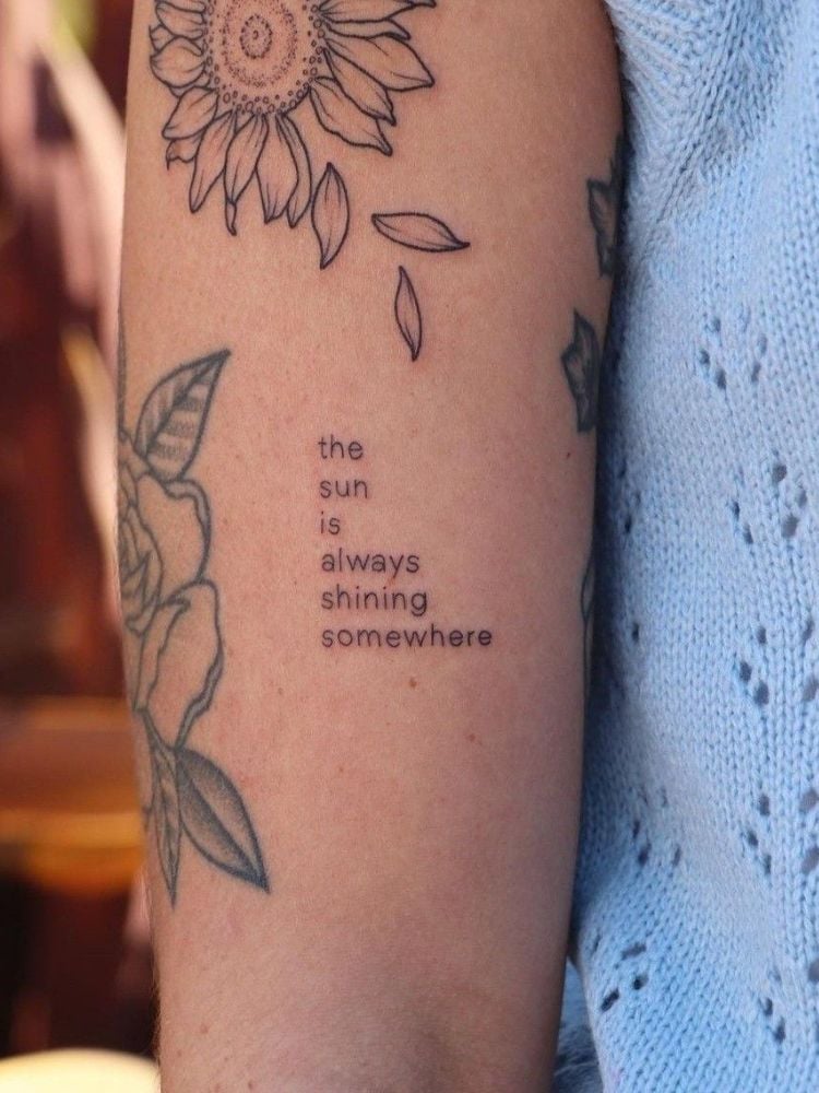 tatuagem com a frase "the sun is always shining somewhere".