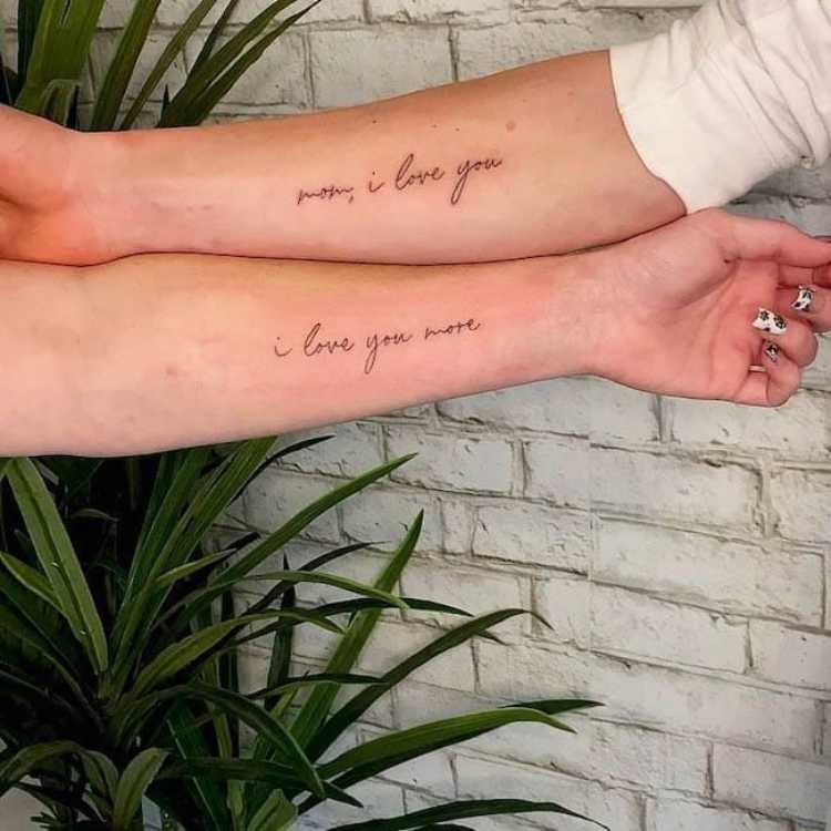 tatuagem escrita "mãe, eu te amo, eu te amo mais", metade em cada braço, duas pessoas