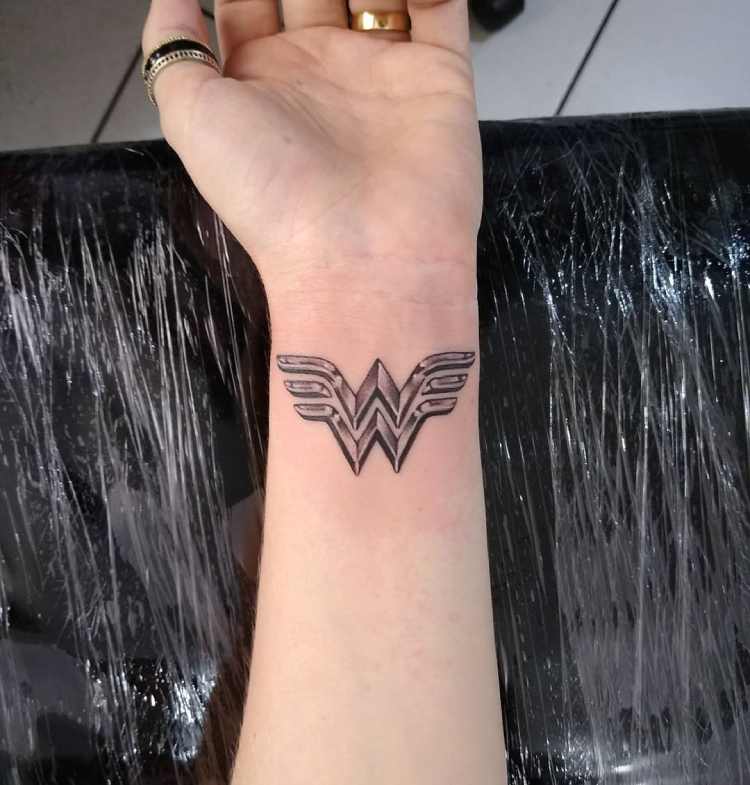 tatuagem símbolo mulher maravilha no pulso