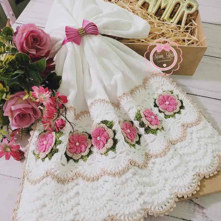 toalha de rosto adornada com babado de crochê e flores de crochê
