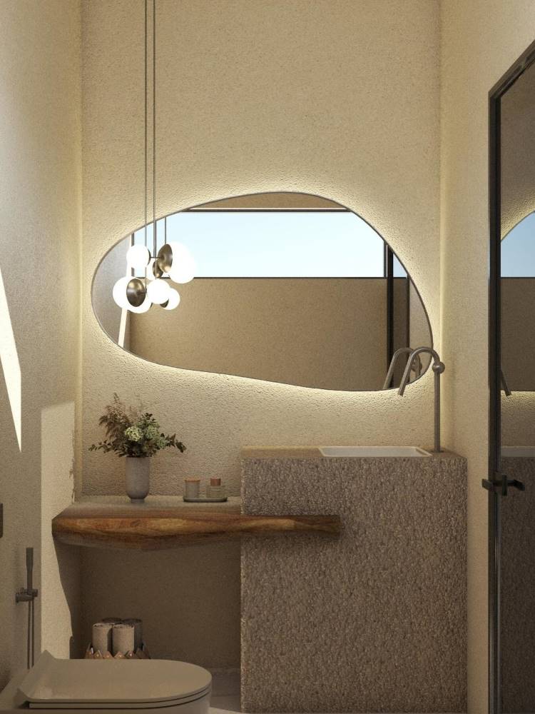 Bancada de banheiro co pedra natural, detalhe em madeira, planta e espelho orgânico. 