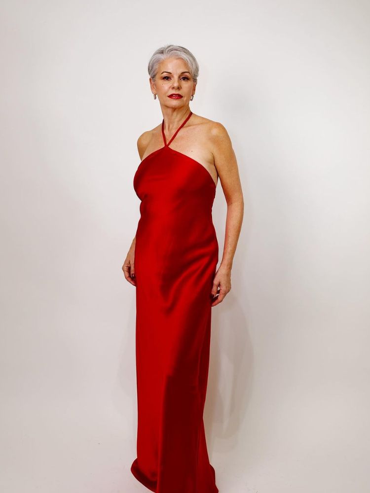 Angelica Lucia Partidas usando vestido vermelho longo de cetim em look para confraternização de fim de ano