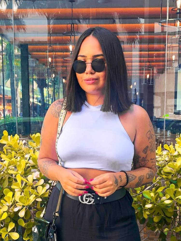Mulher de pele morena com cabelo preto reto na altura do ombro 