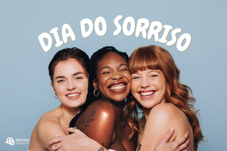 Mulheres sorrindo se abraçando e frase: Dia do Sorriso