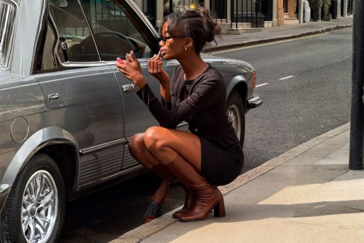 Mulher usando bota de cano alto, uma das tendências de sapatos para o inverno 2026